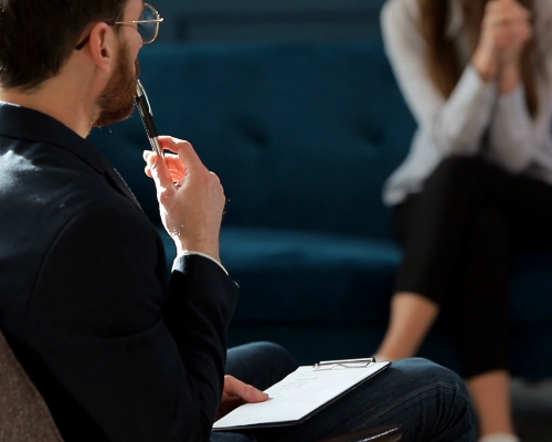 videoblocks young woman visiting male psychologist sitting on the comfortable couch during psychological session in the luxury blue office interior htercvsdvn thumbnail 1080 01